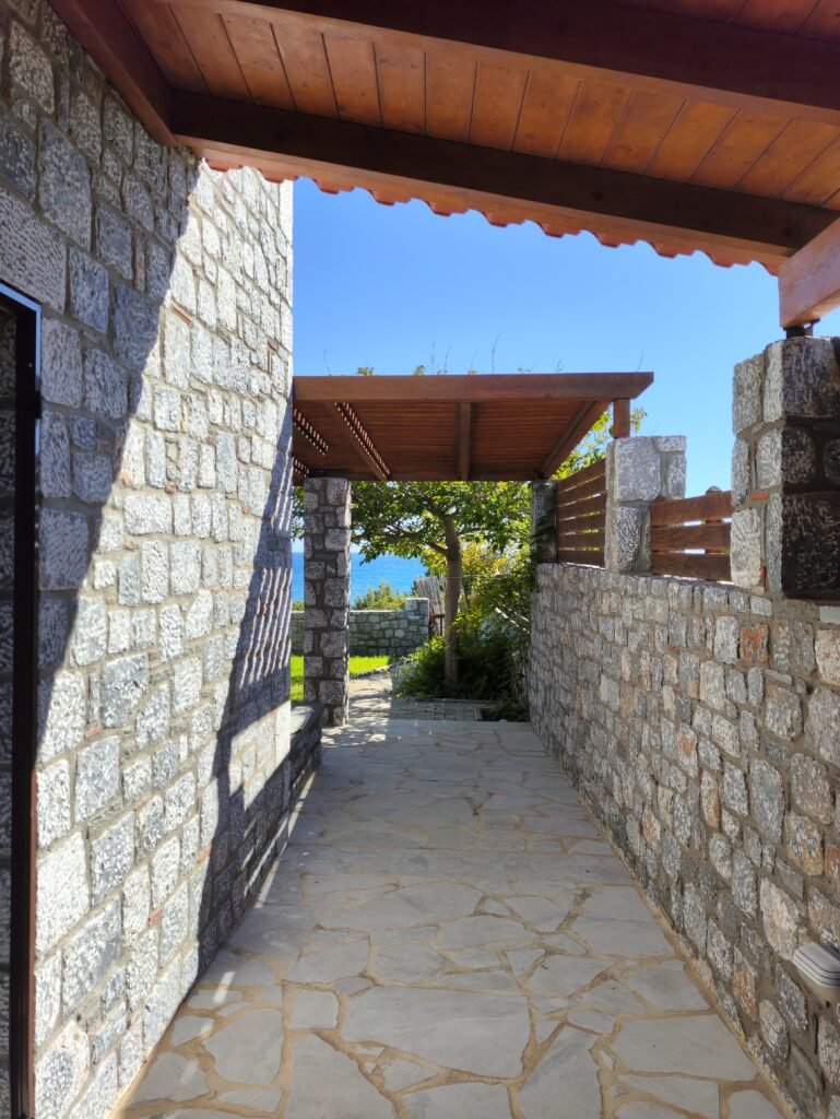 img 20251012 150320 Stone-built corridor along the side of Alisahni Villas leading to the garden in Kiotari, Rhodes.