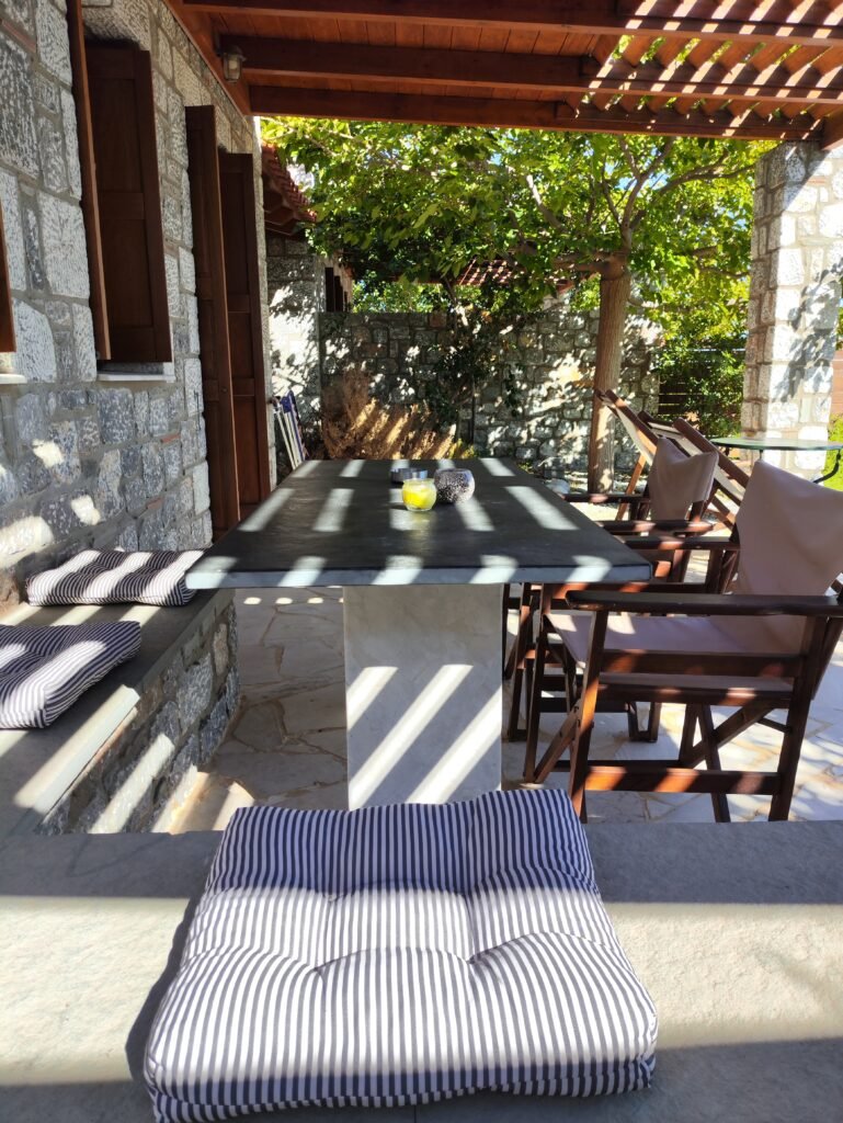 Veranda with outdoor seating and sea view at Alisahni Villas in Kiotari, Rhodes.